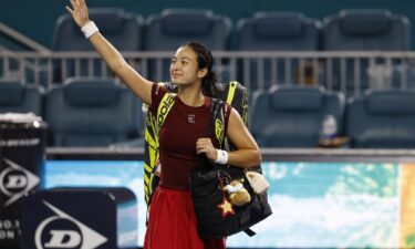Alexandra Eala waves to fans while leaving the court after her match against Jessica Pegula.