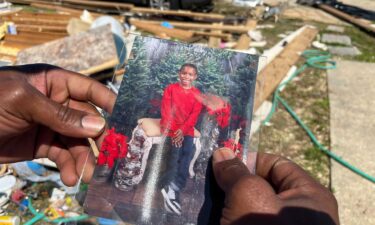 Carter Young’s father holds a picture of the 7-year-old who was killed in the March 15 tornadoes.
