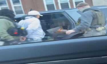 Cellphone video shows a man being taken into custody by law enforcement in Chelsea on Tuesday