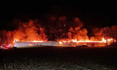 The barn was fully engulfed in flames with thick smoke billowing from the structure.