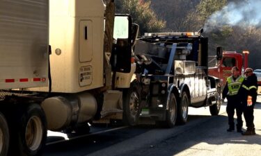 A tractor trailer is towed away from a 16-vehicle pileup that happened on March 17 on Interstate 26 in Henderson County.