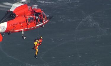 Chopper 7 captures a firefighter being pulled into a helicopter after first responders rescued a person from Lake Chemung in Brighton.
