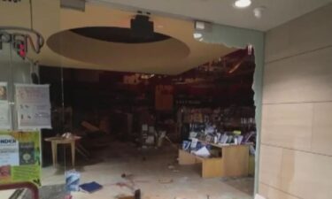A car bursts into flames after crashing into the Book of Jewel bookstore in Westchester causing significant damage.