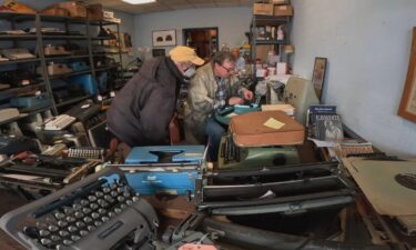 Tom Furrier is pictured with a customer in Cambridge Typewriter Co. in Arlington.