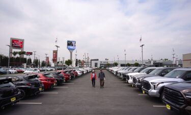 Two people shop at a Toyota dealership in El Monte