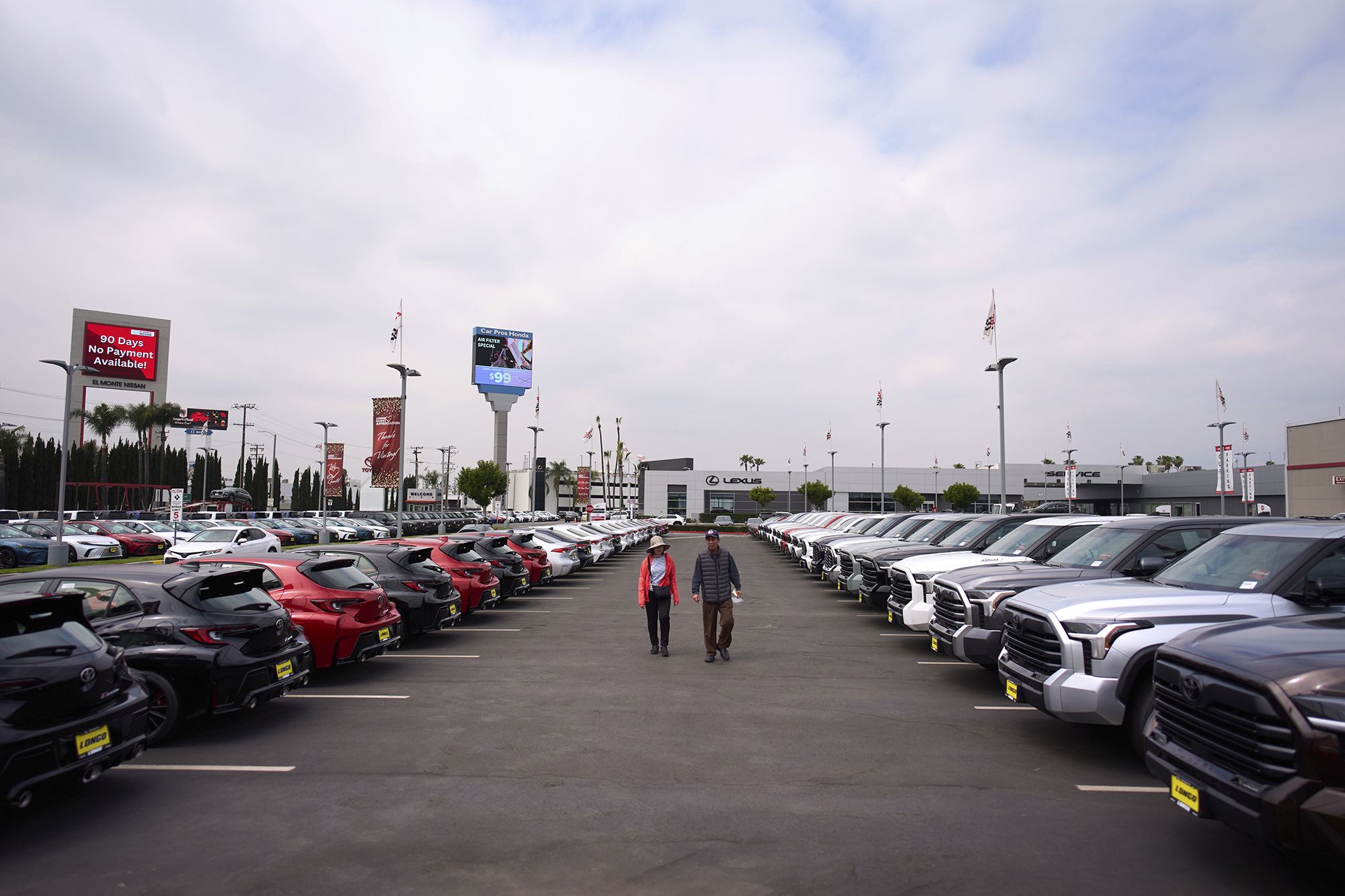 <i>Jae C. Hong/AP via CNN Newsource</i><br/>Two people shop at a Toyota dealership in El Monte
