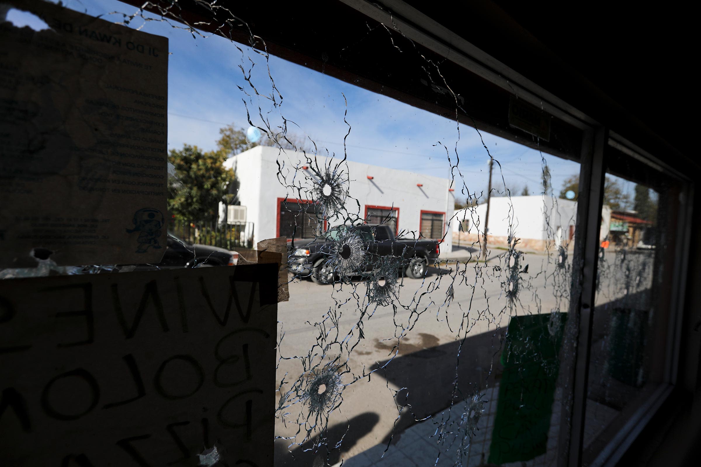 <i>Eduardo Verdugo/AP/File via CNN Newsource</i><br/>A shop's windows are riddled with bullets after a gun battle between a heavily armed drug cartel assault group and security forces in Villa Union