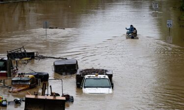 An American flag flies on the porch of a home in a flooded neighborhood on Sunday