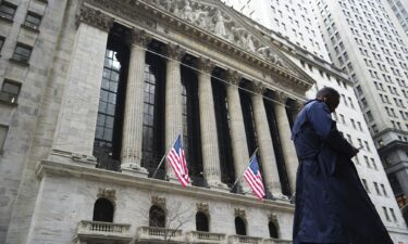 A pedestrian walks past the New York Stock Exchange.
