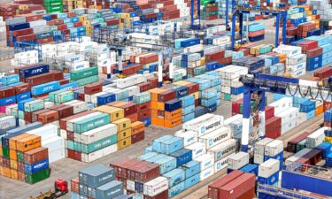 Shipping containers are stacked at a port in Yantai