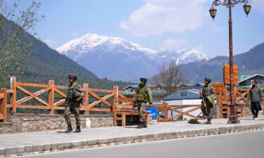 Jammu and Kashmir National Conference members attend a protest after tourists were killed