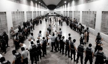 Salvadoran police officers escort alleged members of the Venezuelan gang Tren de Aragua recently deported by the US government to be imprisoned in the Terrorism Confinement Center (CECOT) prison in Tecoluca