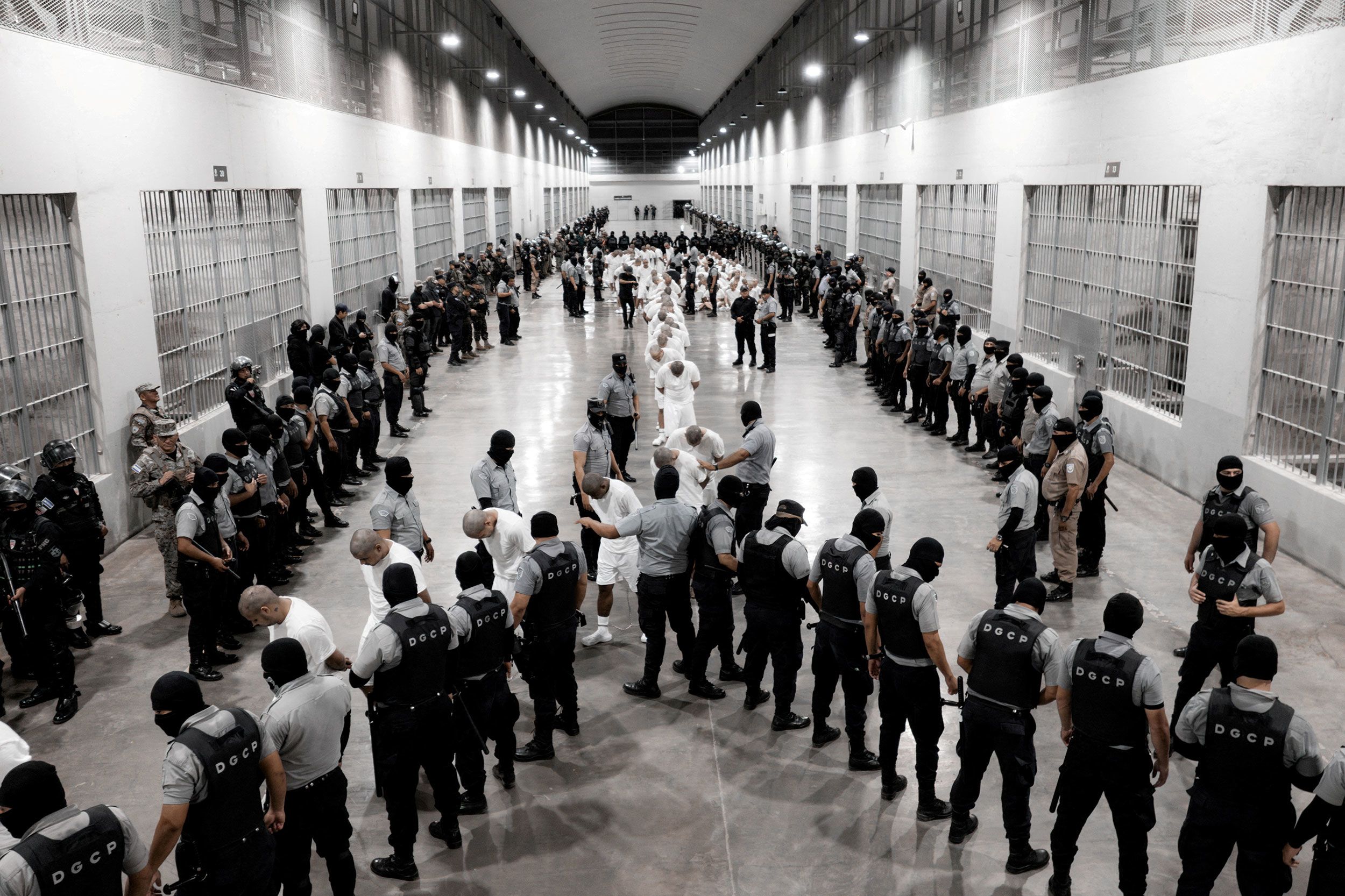<i>Secretaria de Prensa de la Presidencia/Handout/Reuters via CNN Newsource</i><br/>Salvadoran police officers escort alleged members of the Venezuelan gang Tren de Aragua recently deported by the US government to be imprisoned in the Terrorism Confinement Center (CECOT) prison in Tecoluca