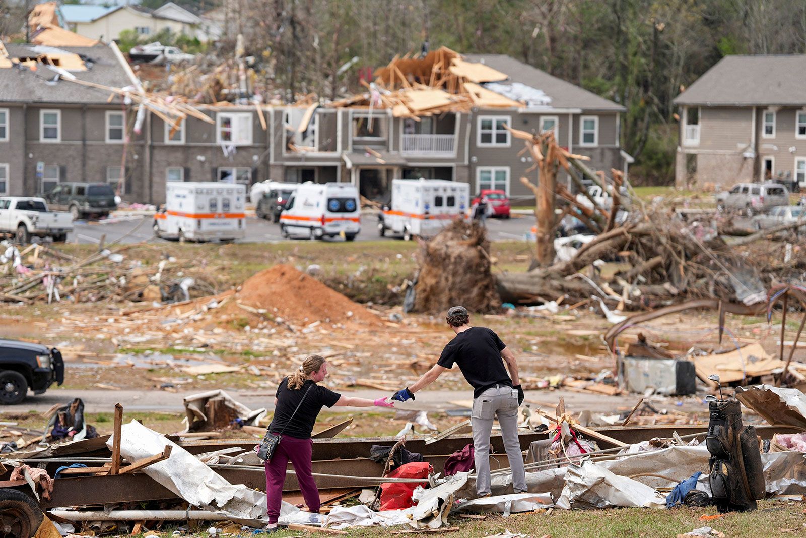 <i>Chris Day/The Commercial Appeal/USA Today Network/Reuters via CNN Newsource</i><br/>Jesse Furman is handed one of her belongings by Brayden McLemore near her destroyed trailer in Selmer