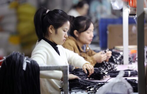 Workers process electronic products