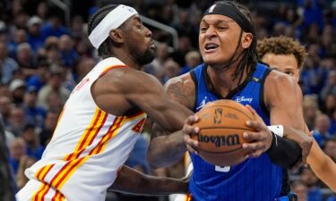 Orlando Magic forward Paolo Banchero is fouled by Atlanta Hawks guard Caris LeVert as he goes up for a shot during Tuesday's NBA play-in tournament game.