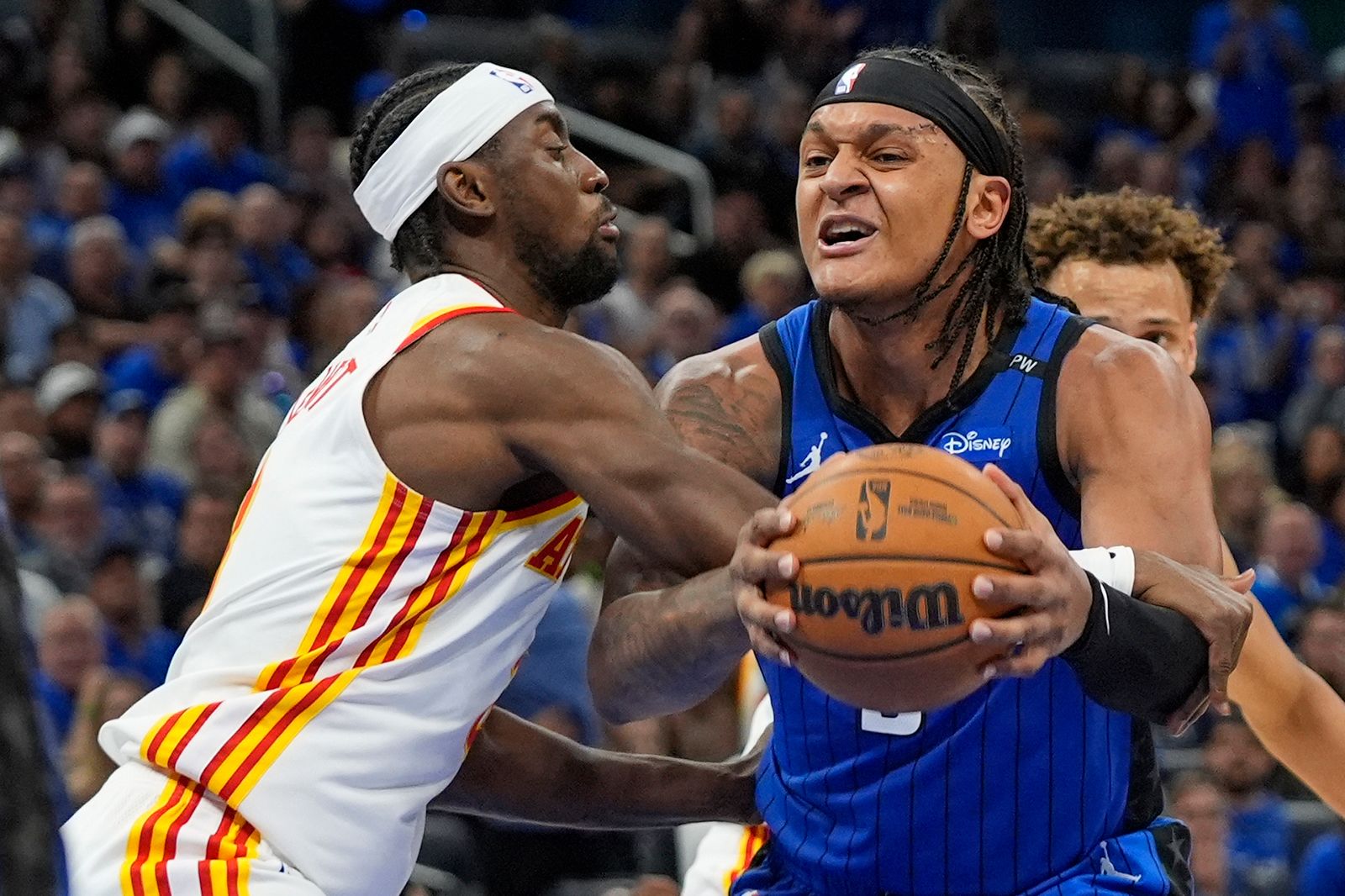 <i>John Raoux/AP via CNN Newsource</i><br/>Orlando Magic forward Paolo Banchero is fouled by Atlanta Hawks guard Caris LeVert as he goes up for a shot during Tuesday's NBA play-in tournament game.