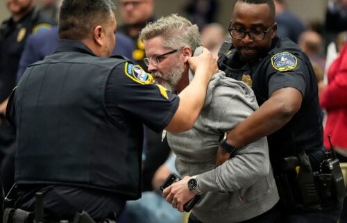 Police remove a protester from an event with Rep. Marjorie Taylor Greene in Acworth