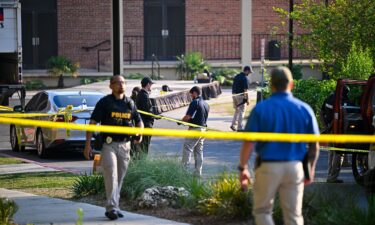 A student honors the deceased and injured students near the scene of a shooting at the Florida State University student center on April 18