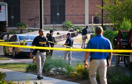 A student honors the deceased and injured students near the scene of a shooting at the Florida State University student center on April 18