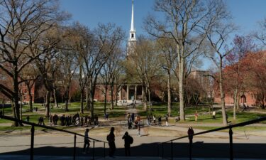 People cross the Harvard Yard at Harvard University on April 17