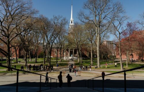People cross the Harvard Yard at Harvard University on April 17
