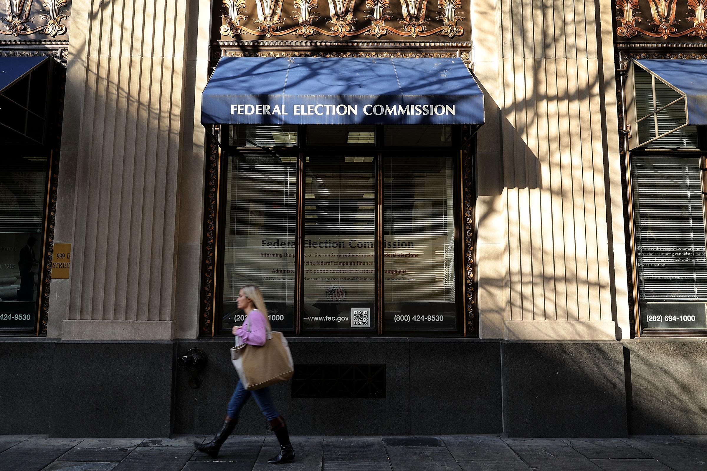 <i>Chip Somodevilla/Getty Images via CNN Newsource</i><br/>A pedestrian walks past the Federal Election Commission's headquarters in October 2016