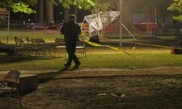 A Pasquotank County Sheriff's Deputy is seen placing crime scene tape around the front of Williams Hall