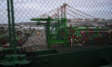 Cranes unload cargo shipping containers at the Port of Los Angeles in San Pedro