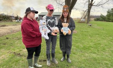 Ashley Richardson (center) holding her son’s ashes with sisters-in-law