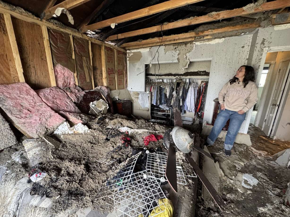 <i>KSL via CNN Newsource</i><br/>Holly Hendrickson looks at the damage to her master bedroom after a fire on April 26.