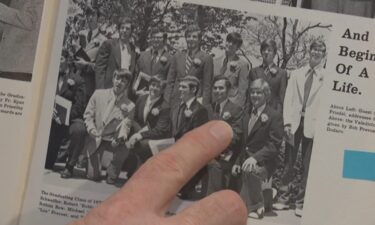 Bob Schick points to a picture of Robert Prevost in his high school yearbook.