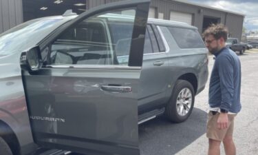 John Tibbs looks at the used Suburban he bought