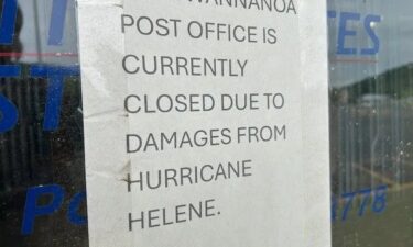 A closed sign on the front of the Swannanoa post office over seven months after Hurricane Helene hit.