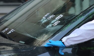 Crime scene investigators at the site where the personal secretary and an adviser to Mexico City's mayor were killed by gunmen on a motorcycle