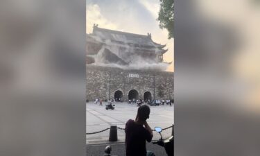 This screengrab taken from a video shows roof tiles collapsing from a centuries-old Chinese drum tower in Anhui