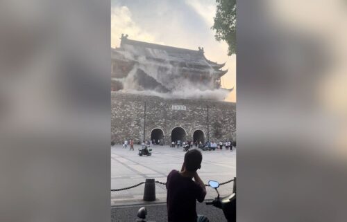 This screengrab taken from a video shows roof tiles collapsing from a centuries-old Chinese drum tower in Anhui