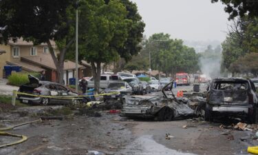 Authorities work the scene where a small plane crashed into a San Diego neighborhood