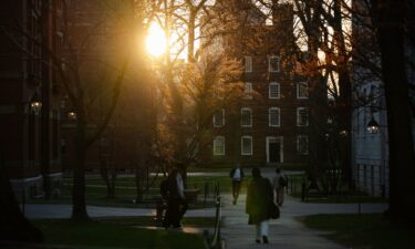 Students walk through campus at Harvard University on April 17 in Cambridge
