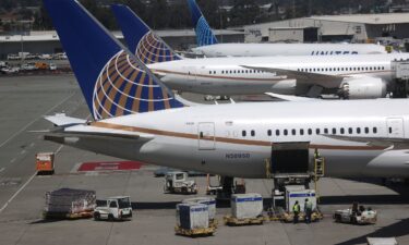 United Airlines workers load cargo onto a plane at the San Francisco International Airport in July 2020. Two airline planes clipped wings in San Francisco on May 6.
