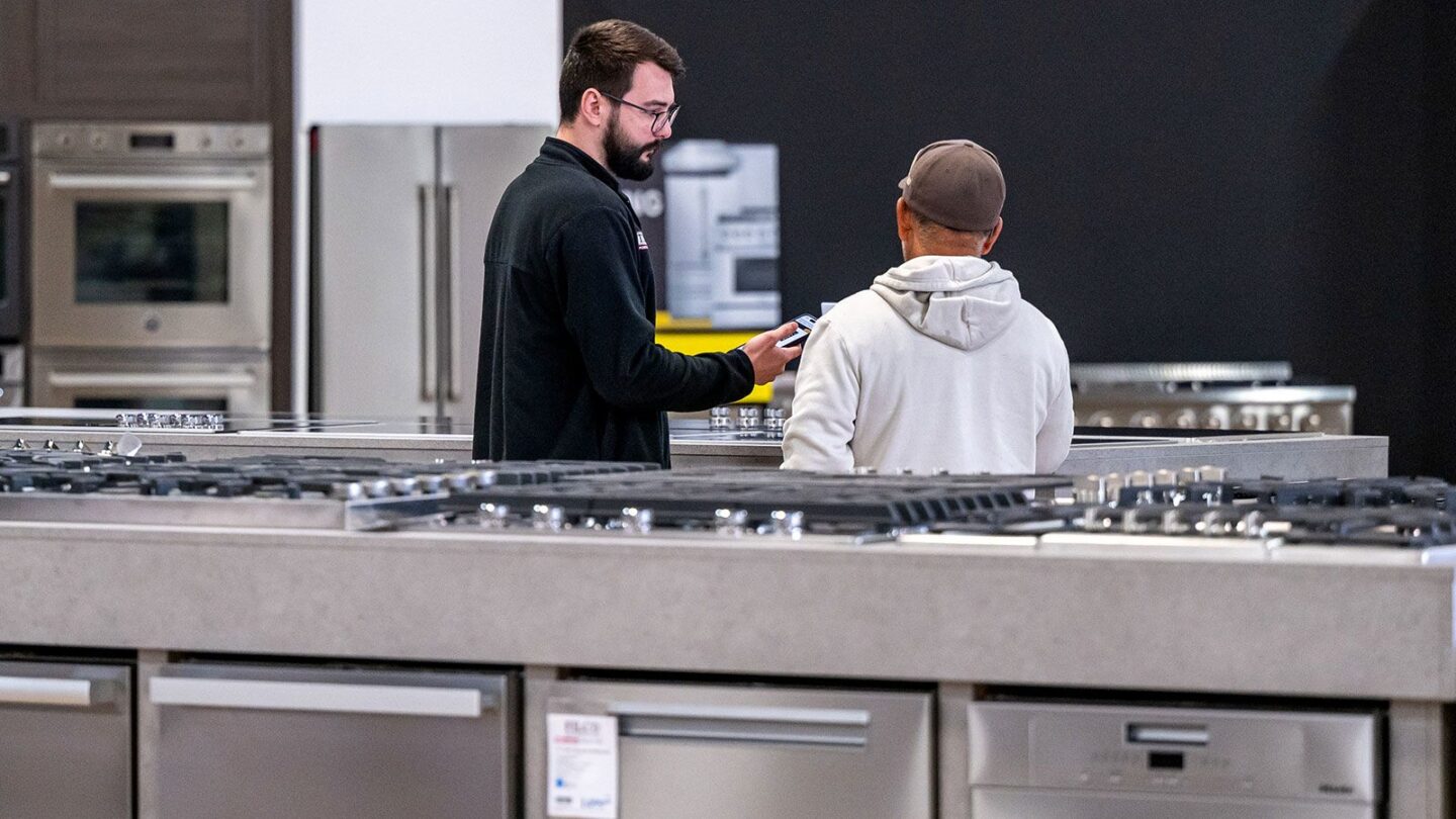<i>David Paul Morris/Bloomberg/Getty Images/File via CNN Newsource</i><br/>A salesperson assists a customer inside an appliance store in Sacramento