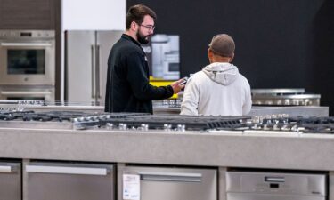 A salesperson assists a customer inside an appliance store in Sacramento