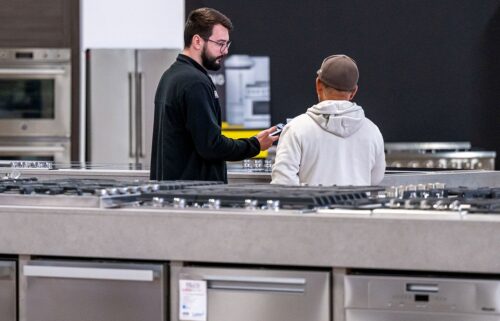 A salesperson assists a customer inside an appliance store in Sacramento