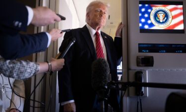 President Donald Trump listens to questions as he speaks to members of the press on Air Force One while flying over Saudi Arabia on his way to Qatar on May 14.