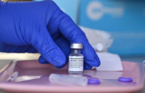 A nurse reaches for a vial of Pfizer-BioNTech Covid-19 vaccine at a pop up vaccine clinic in the Arleta neighborhood of Los Angeles