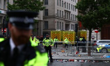 A person is taken away on a stretcher following a car collision in Liverpool on Monday.