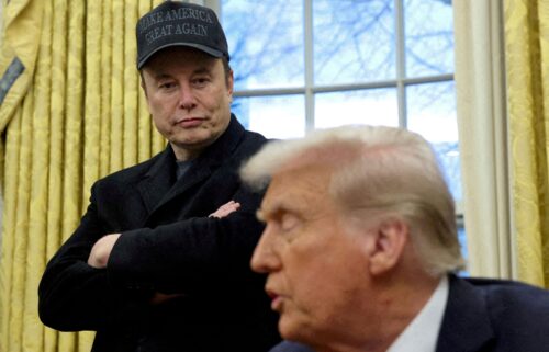 Elon Musk listens to President Donald Trump speak in the Oval Office of the White House in Washington