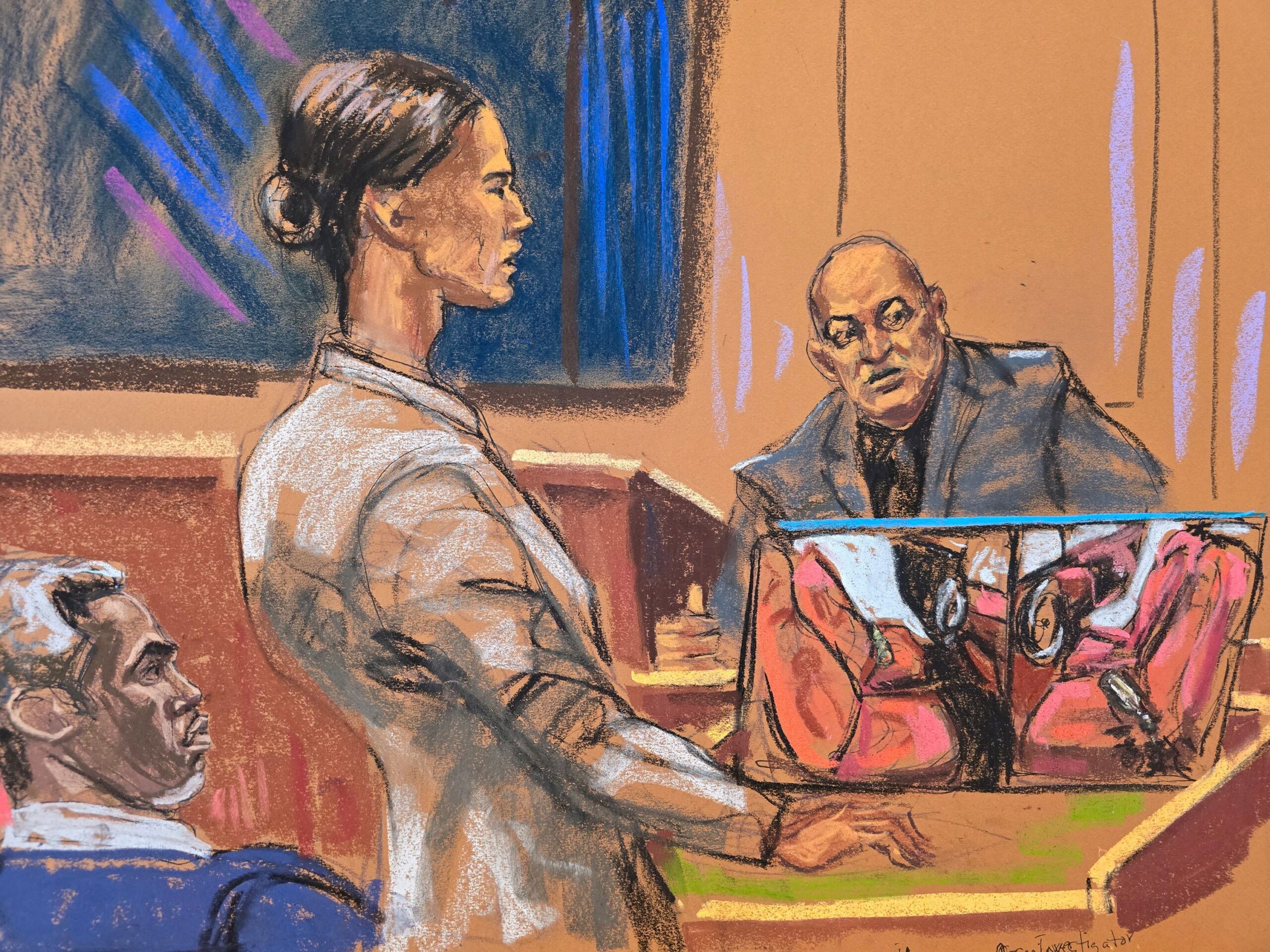 <i>Jane Rosenberg/Reuters via CNN Newsource</i><br/>Sean "Diddy" Combs watches as prosecutor Christy Slavik questions Los Angeles fire arson investigator Lance Jimenez near a photo of the interior of Scott Mescudi's damaged car.