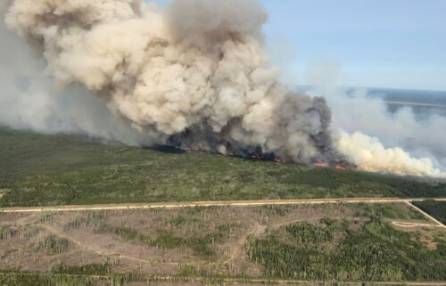 Smoke rises from a wildfire near Wanless