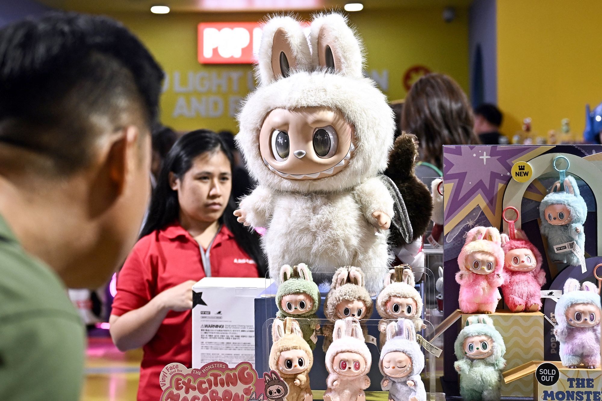 <i>Lillian Suwanrumpha/AFP/Getty Images via CNN Newsource</i><br/>People look at Labubu collectable toys at a Pop Mart pop-up store in Siam Center shopping mall in Bangkok on May 6.